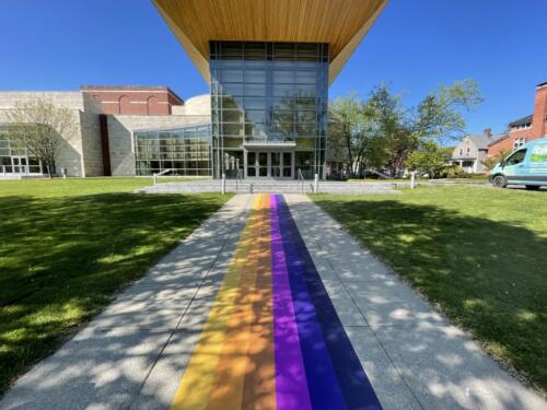 Vibrant color band design for long exterior floor decal leading to building entrance-Custom sidewalk graphics for college alumni event