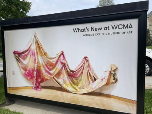Bus shelter banner for local museum promoting current and upcoming exhibitions