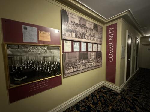 Historical plaques and photos with informational labels mounted to wall