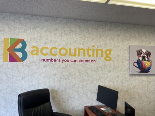 Colorful wall graphics for office interior displaying business's logo and tagline