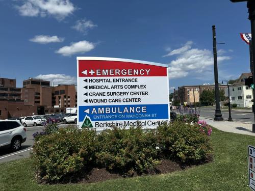 Custom road sign for hospital wayfinding. Directs traffic to Emergency Entrance, Hospital, Medical, Surgery, and Ambulance.