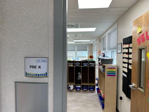 Raised braille and letters on a door identification sign.