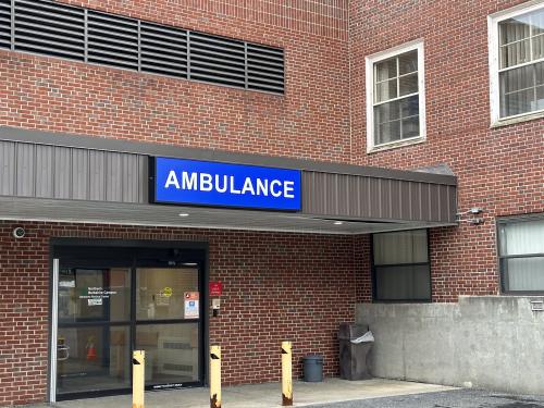 Vinyl covered acrylic sign identifying ambulance entrance.